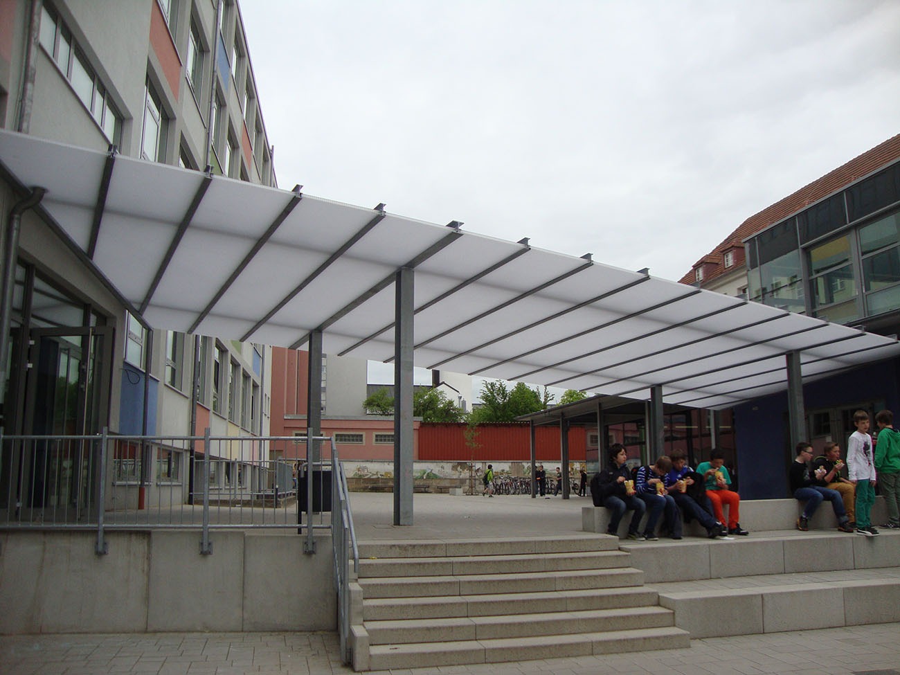 Moxie Surfaces - clear-PEP ECO as covering for walkway in school protects from sun, rain, and snow