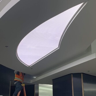 clear-PEP ECO PC stage - backlit ceiling illuminator in shopping mall Moxie Surfaces - clear-PEP ECO PC stage - backlit ceiling illuminator in shopping mall