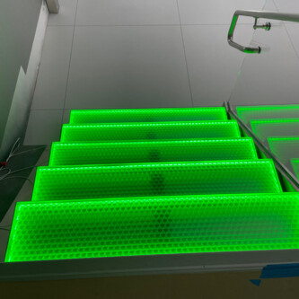 Green backlit stairs with clear-PEP ECO PC stage panels MoxieSurfaces - clear-PEP ECO PC stage - garage backlit stairs