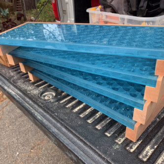 clear-PEP ECO panels in clear blue and satin opal white, complementing a wooden residence with elegant awnings and canopies MoxieSurfaces - clear-PEP ECO panels - Digigloramo Residence