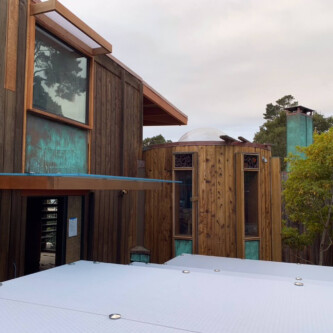 clear-PEP ECO panels in clear blue and satin opal white, complementing a wooden residence with elegant awnings and canopies MoxieSurfaces - clear-PEP ECO panels - Digigloramo Residence